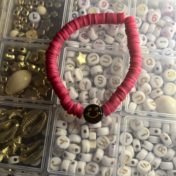 Red and maroon clay bead bracelet with a black and gold smiley face - Picture 1 of 1